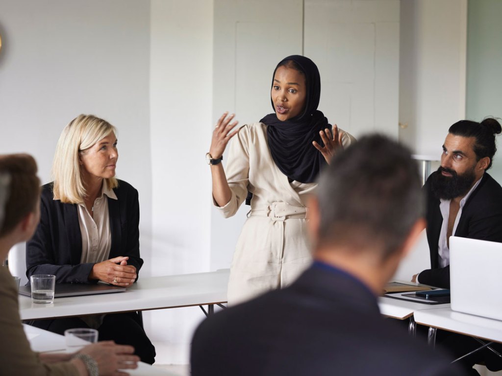 A group of people talking in an office