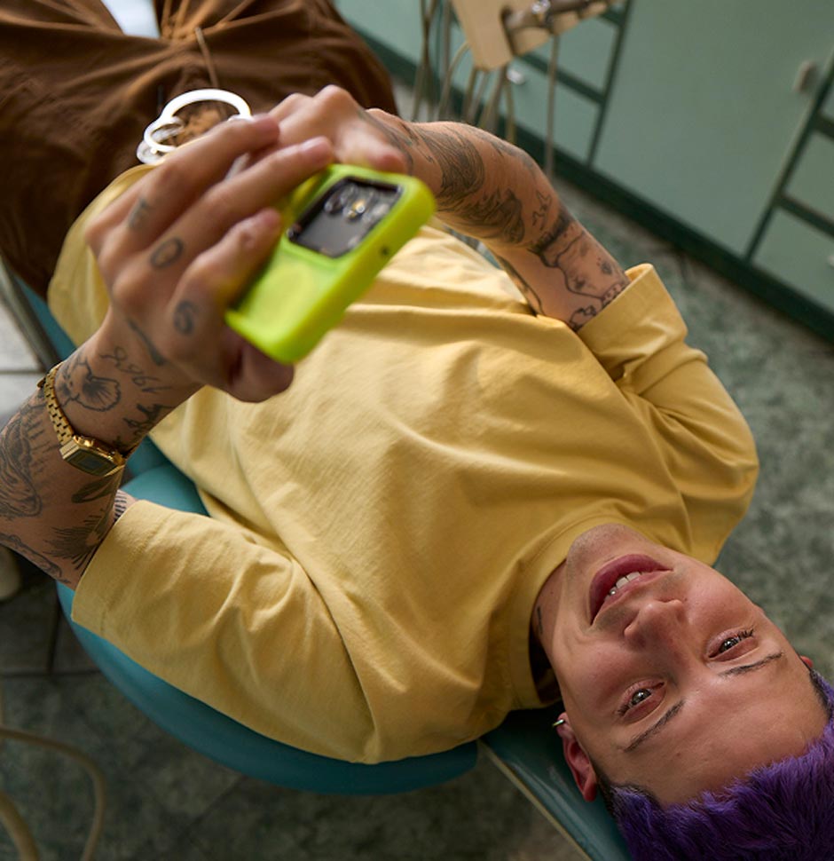 A person whos laying down looking up while using their phone