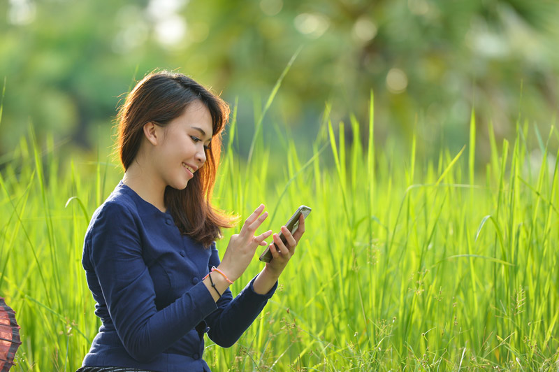 A woman using her phone.