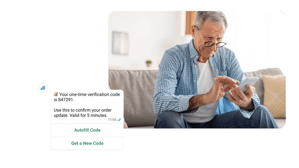 A man looking at a graphic one time verification message received on his phone