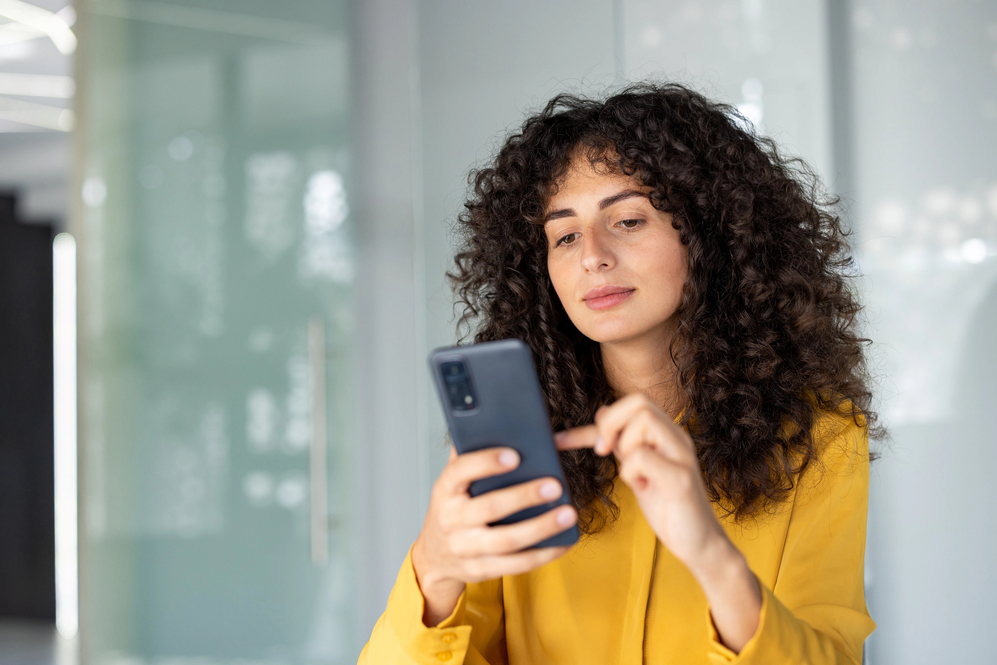 A woman looking at her phone.
