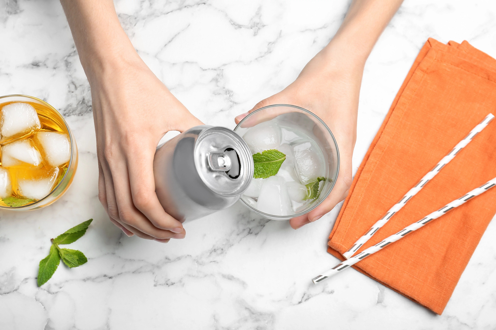 A person pours a beverage.