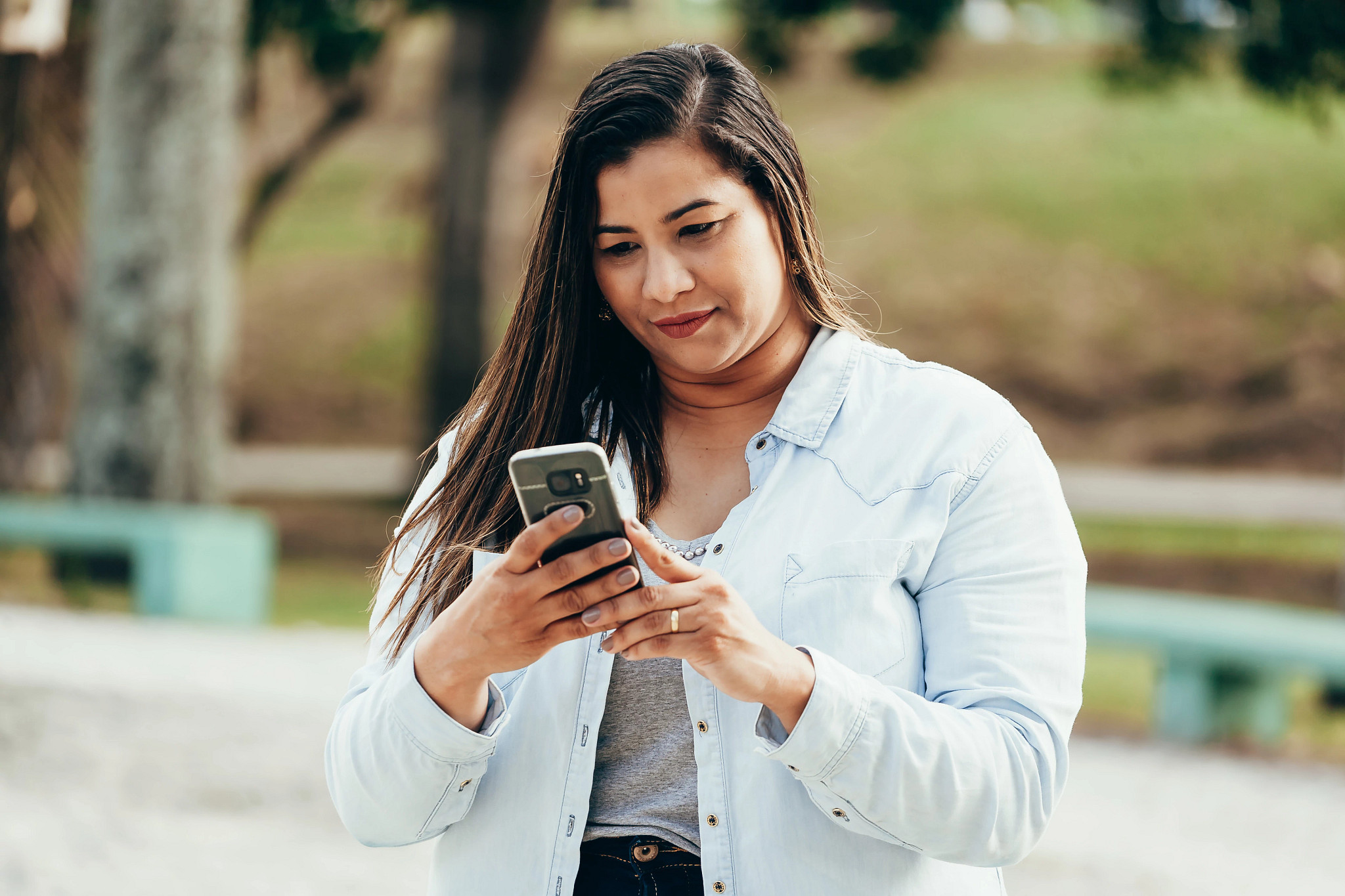 A woman checks her phone.