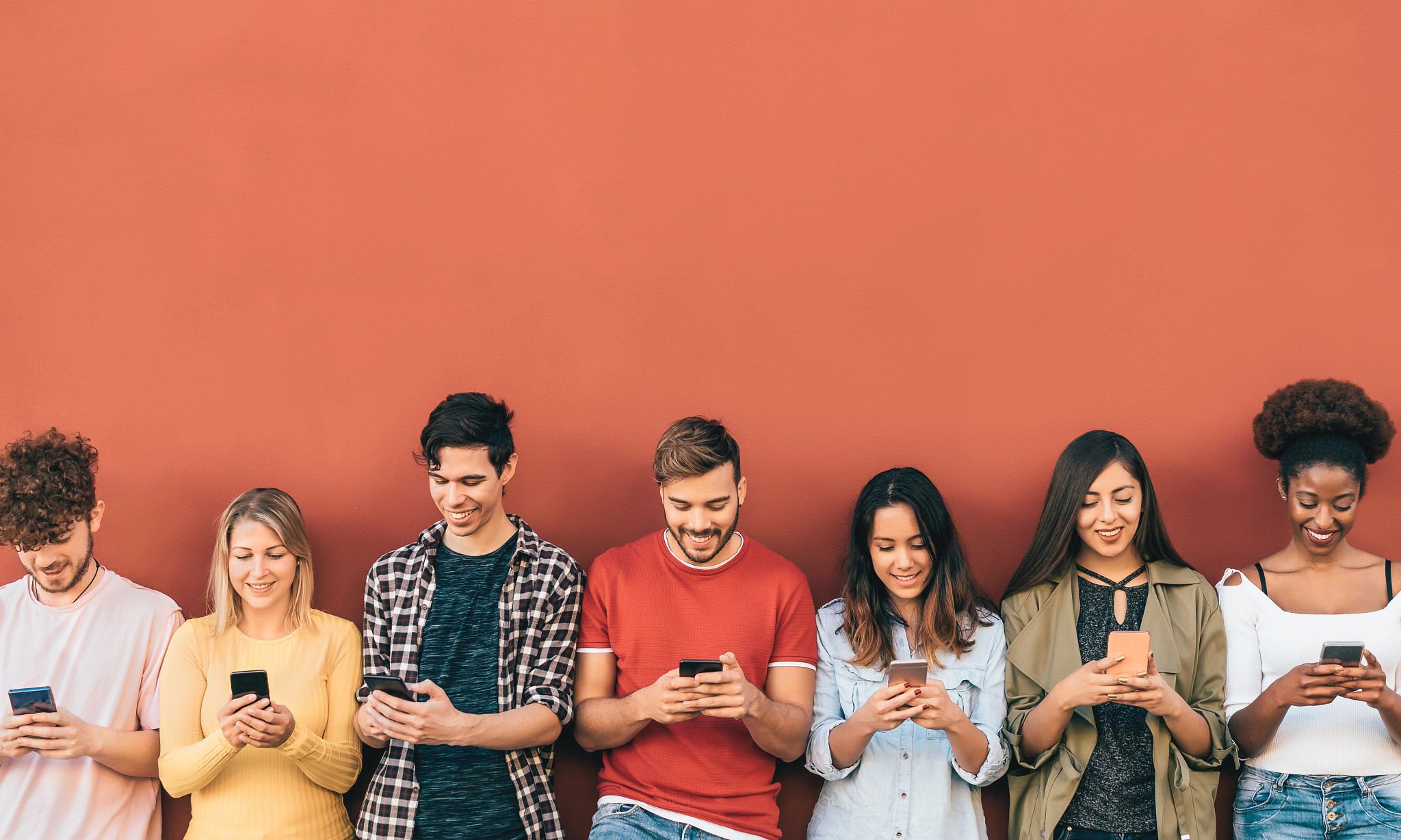 A group of friends using their phones.