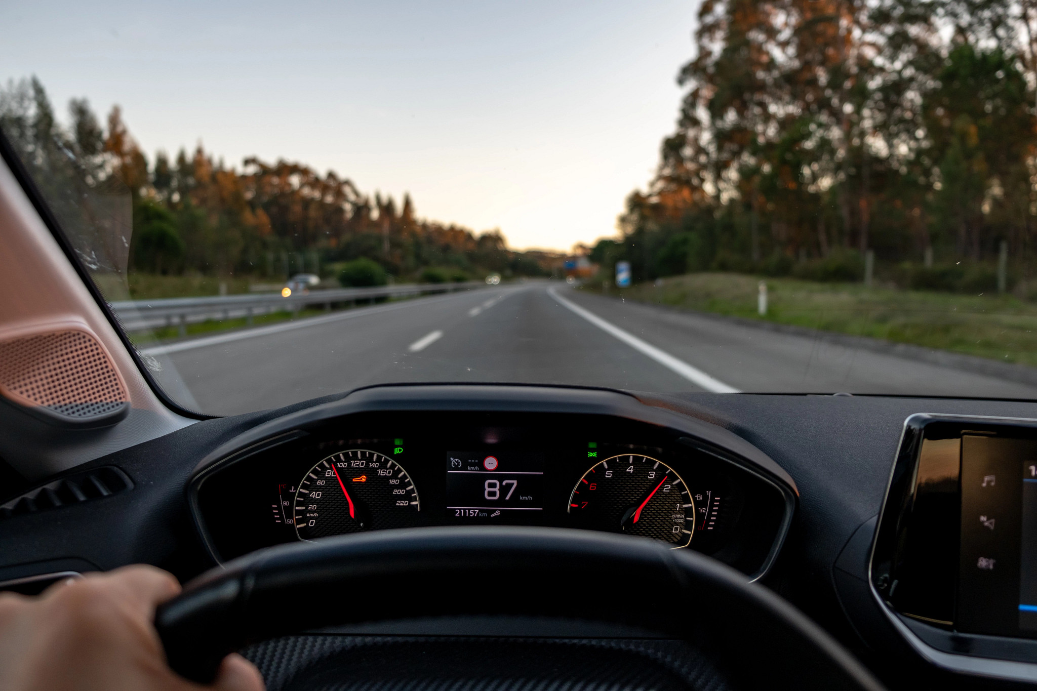 A driver's view through a car's windshield.