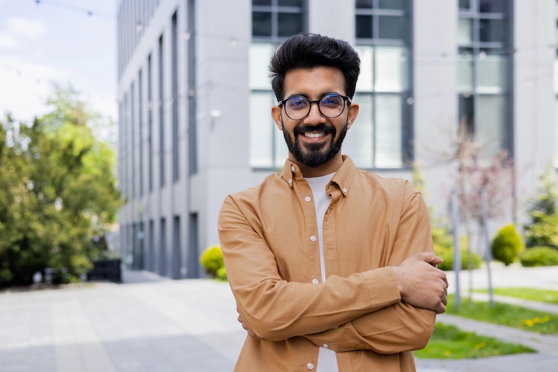 Man smiling with his arms crossed