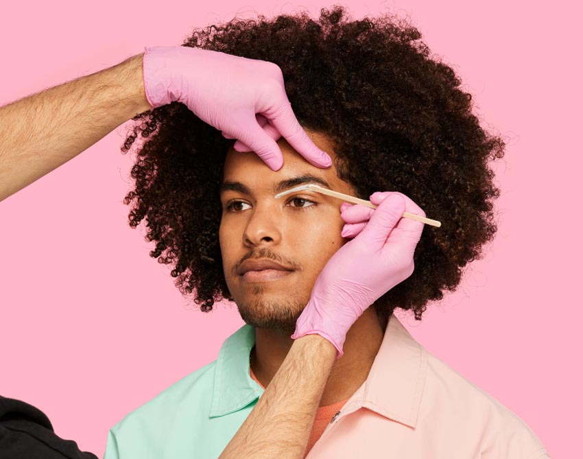 A person getting their eyebrows waxed