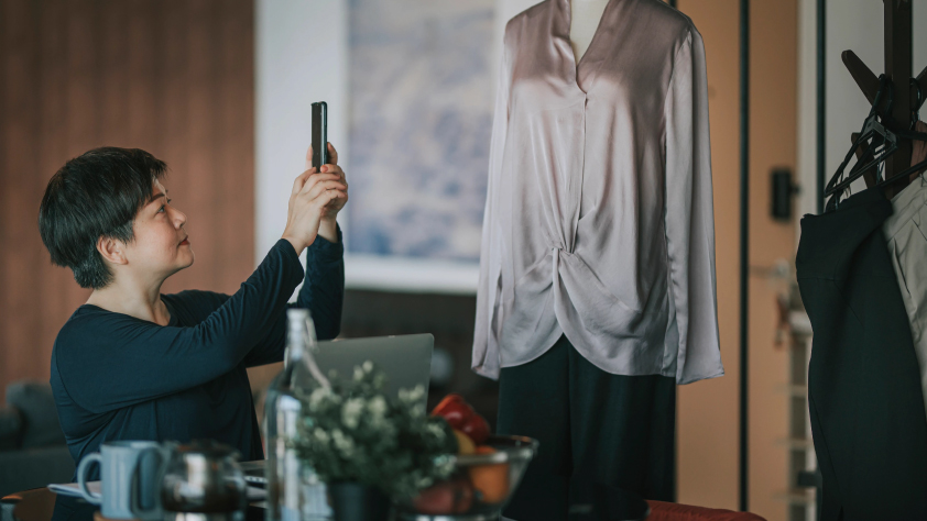 Person taking picture of an outfit on a mannequin