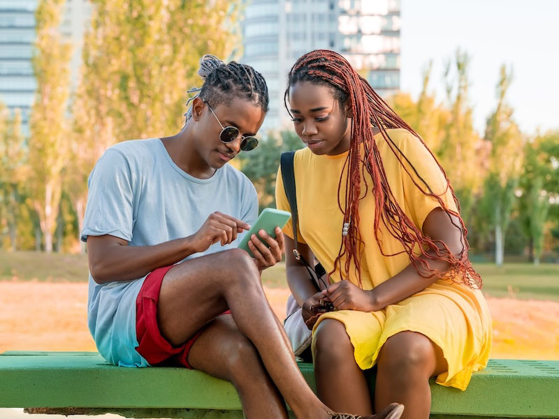 Two people having a discussions looking at a phone