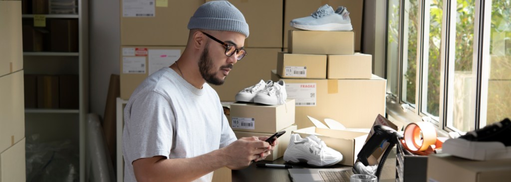 Seseorang menyusun pesanan sepatu online untuk dikirim