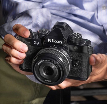 A close up shot of a person's hands holding a camera