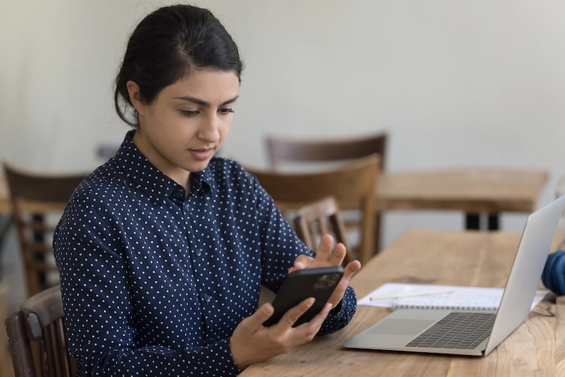 Woman checking her phone for WhatsApp