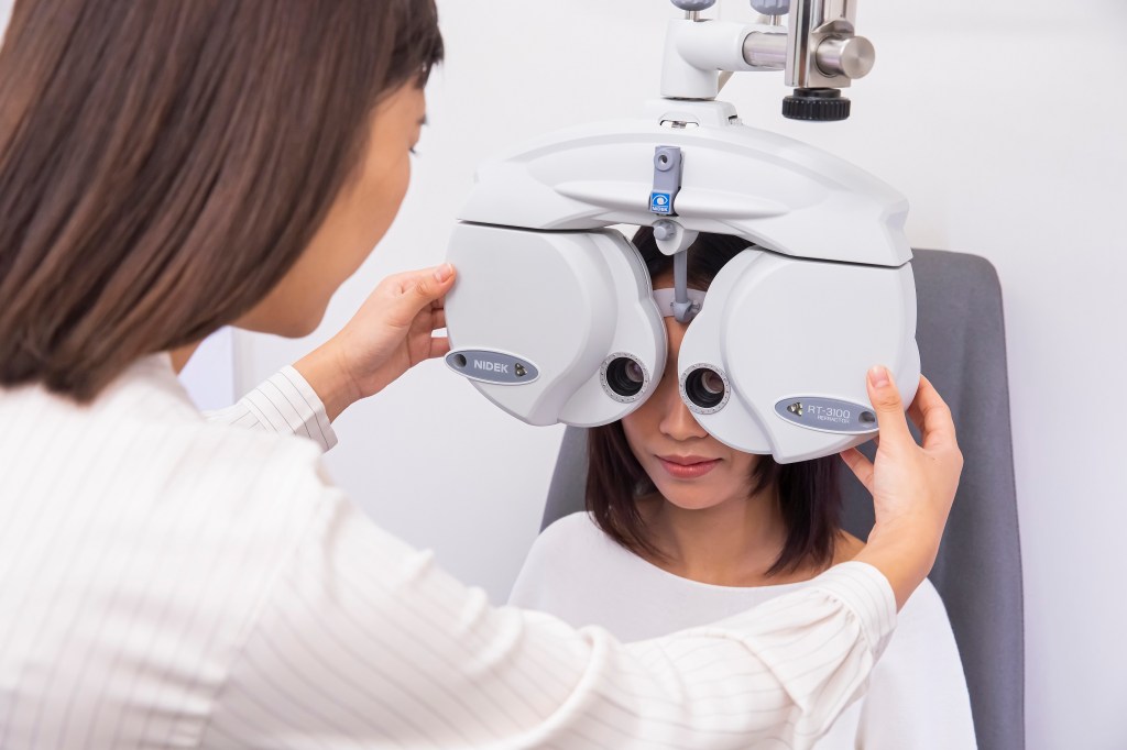 A woman taking an eye exam.