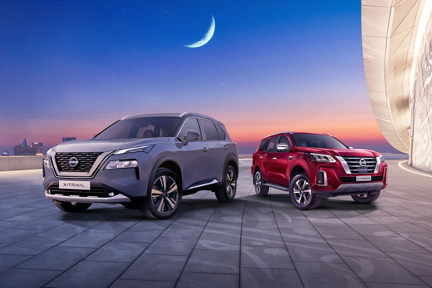 Two Nissan vehicles parked in the moonlight.