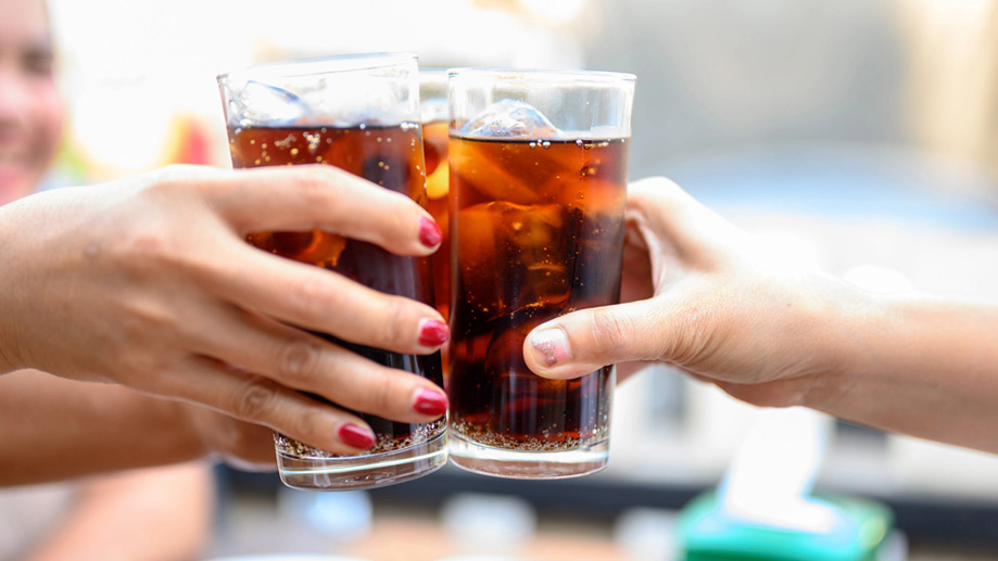 People toasting each other with drinks.