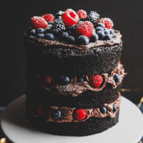 A chocolate layer cake with berries.