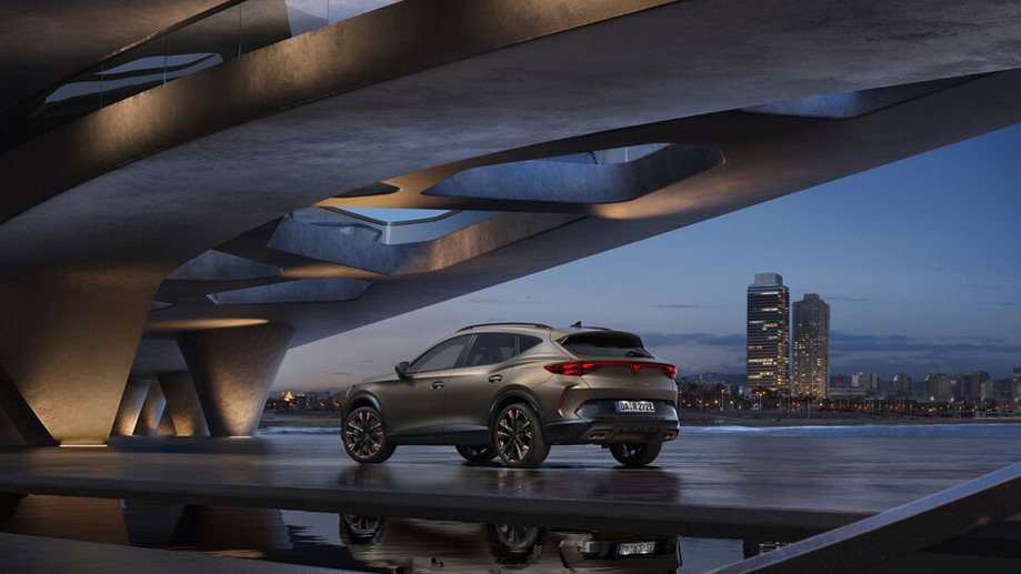 A CUPRA SUV parked overlooking a cityscape.