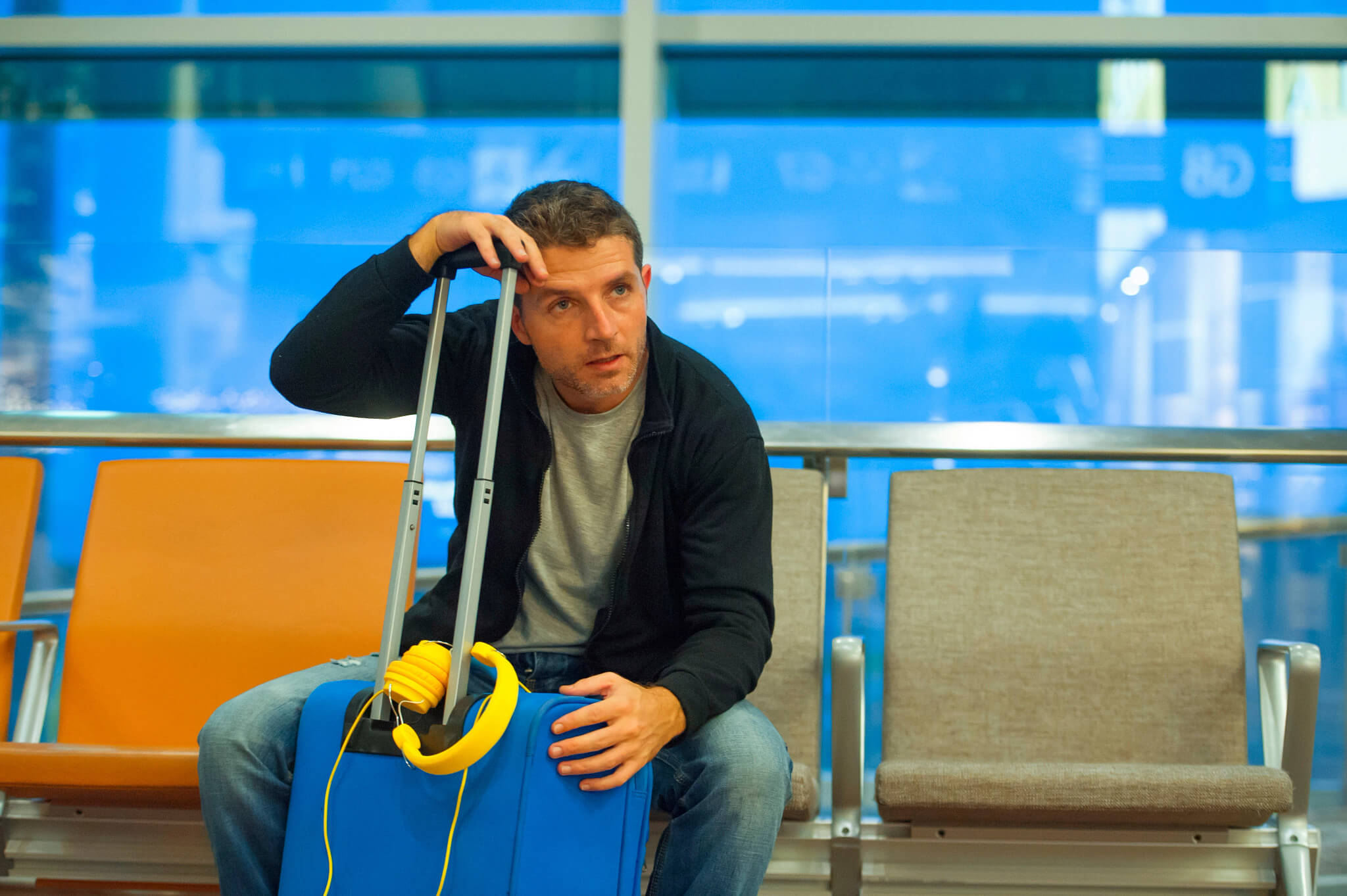 A frustrated man at the airport looking into the distance