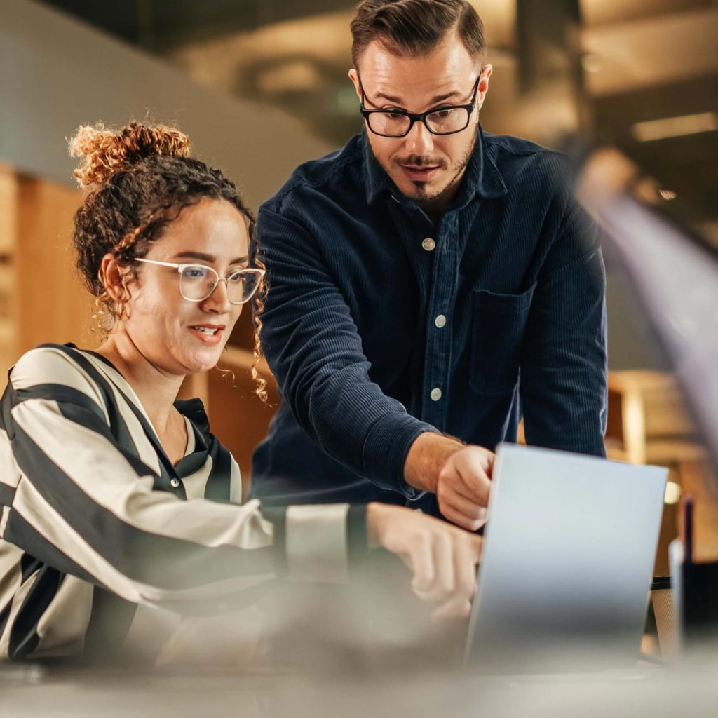 A man and woman discussing what is on the computer