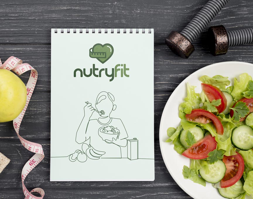 A notepad next to a plate of salad.