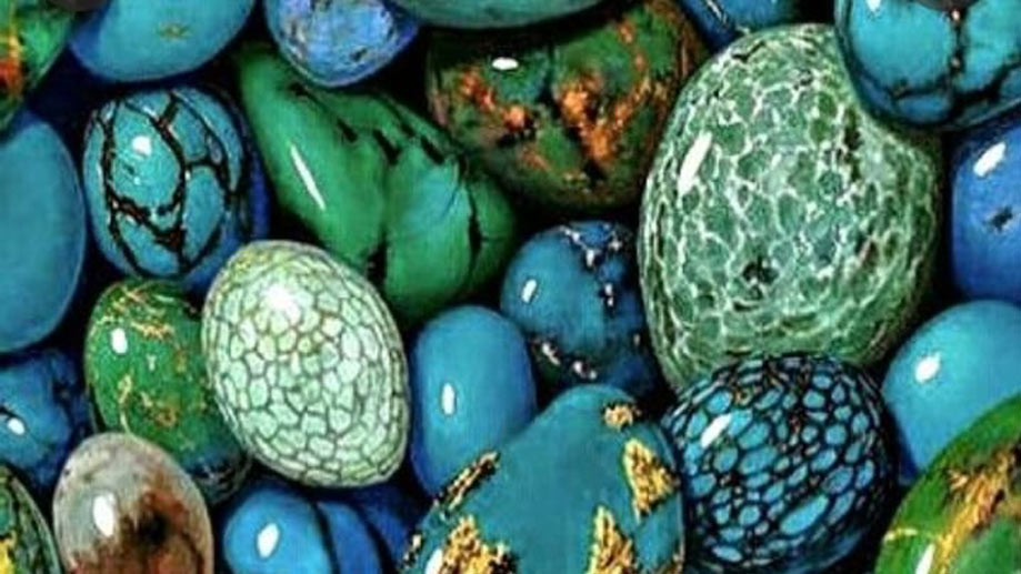  A collection of polished green and blue stones.