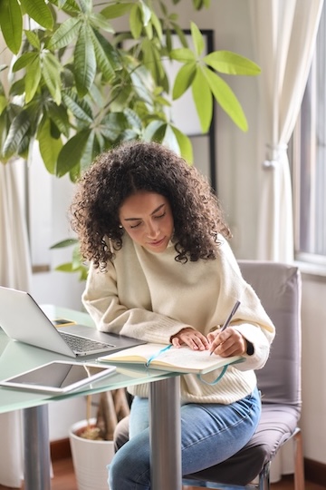 A woman studying at her computer.