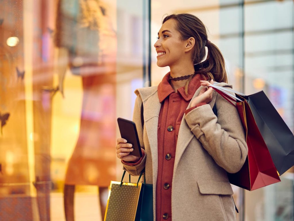 Woman walking around shopping and carrying shopping bags