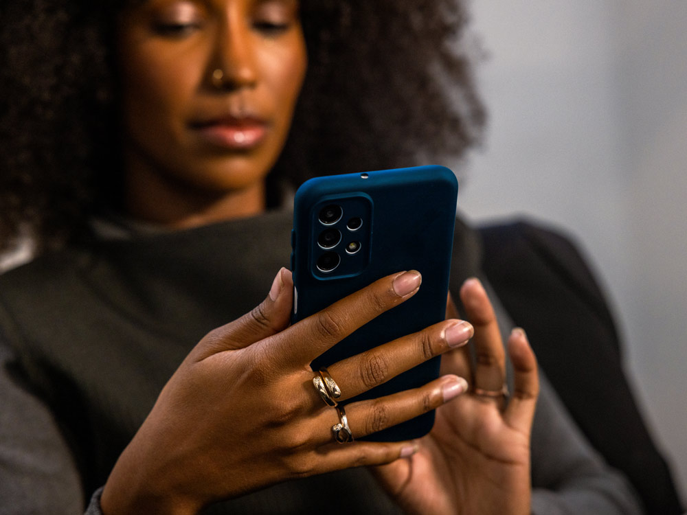 A zoomed in view of a person sitting down using their phone