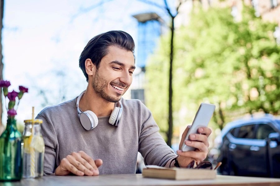 Man sitting at a table looking at his phone