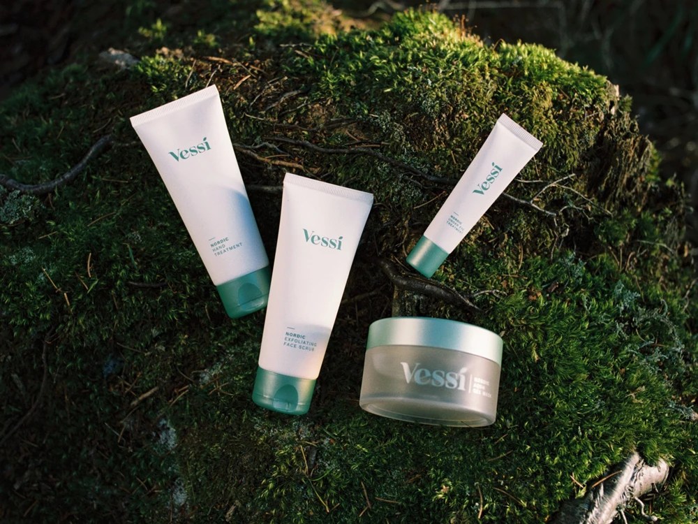 A collection of Vessi products laying in moss