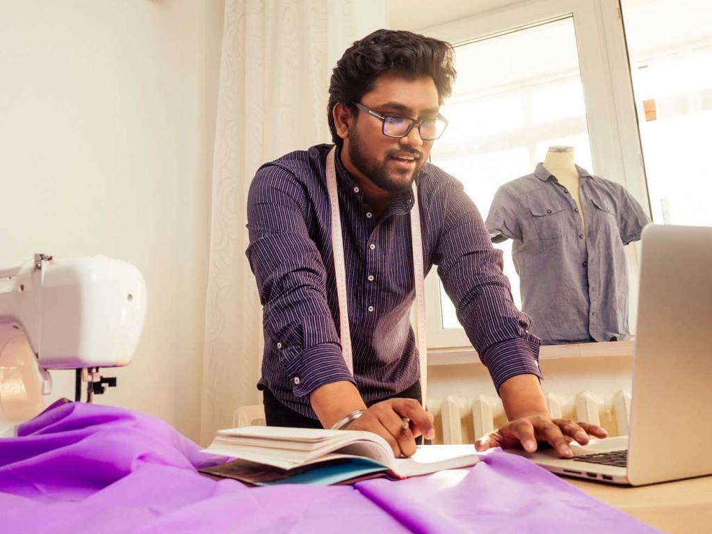 A man looking at his laptop working on his business