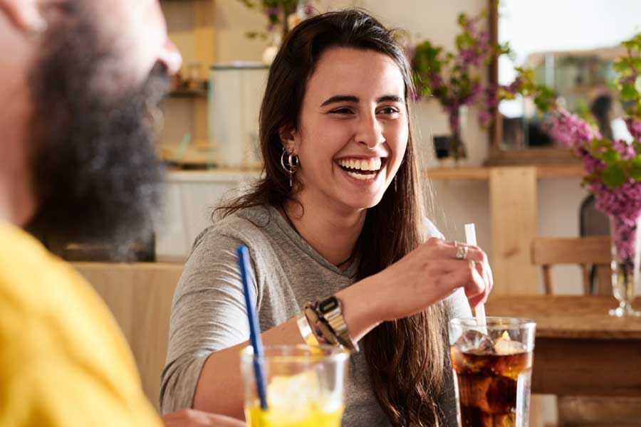 A woman having a coca-cola at the table