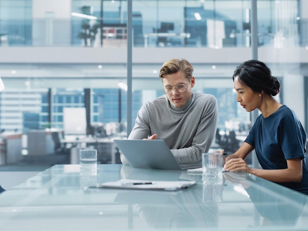 Two people having a business discussion in a conference room