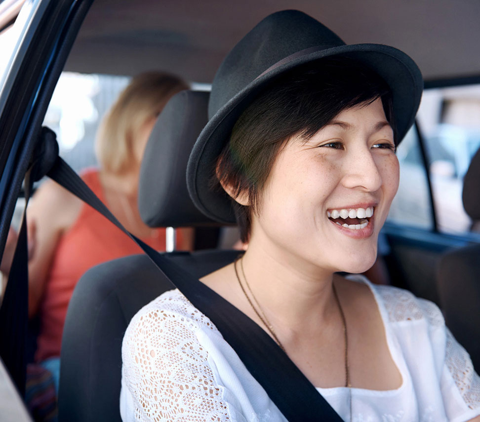 An uber driver taking her passenger to a destination