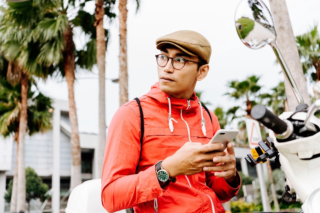 A person holding their phone outside