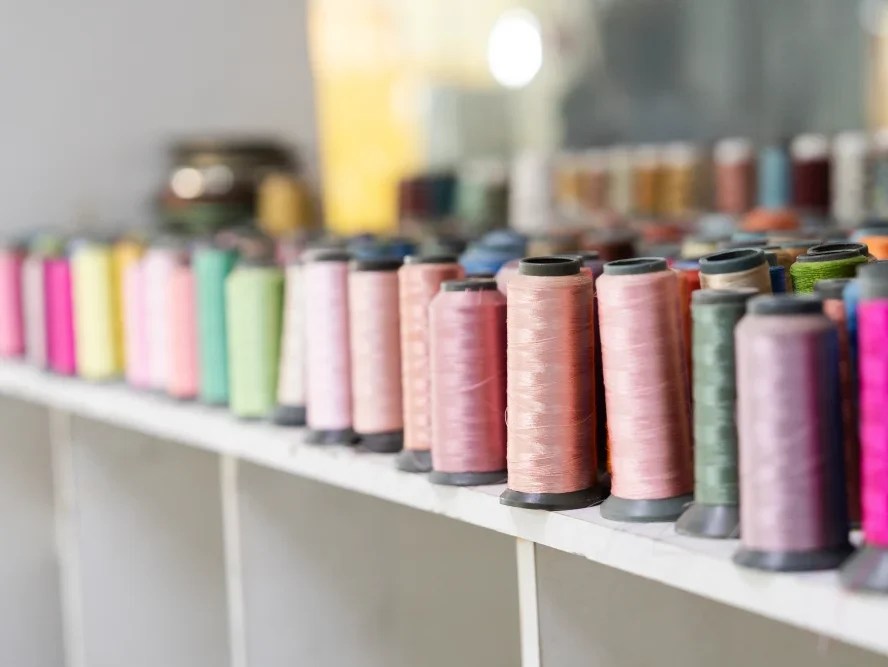 Several looms in different colors on a tabletop