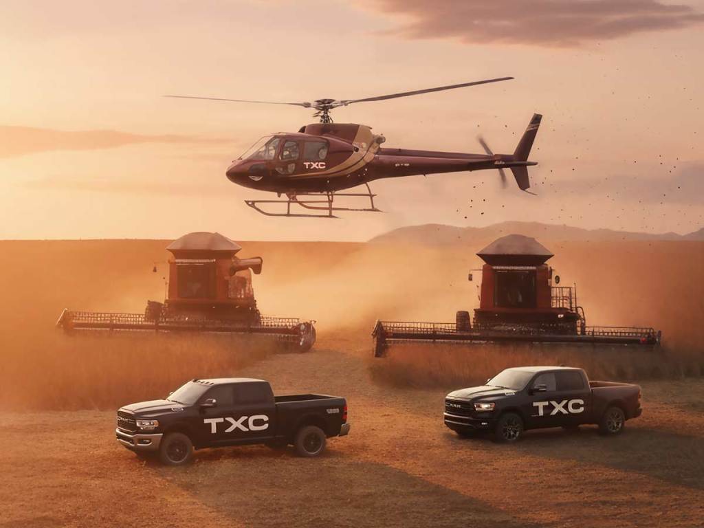 Outdoor shot of TXC branded trucks and a helicopter
