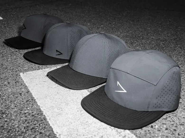 A lineup of apol hats on top of pavement